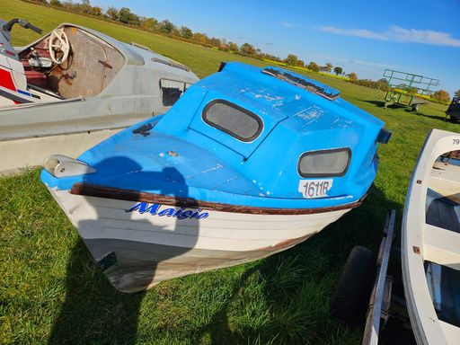 An old motorboat hull suitable as a prop or garden feature